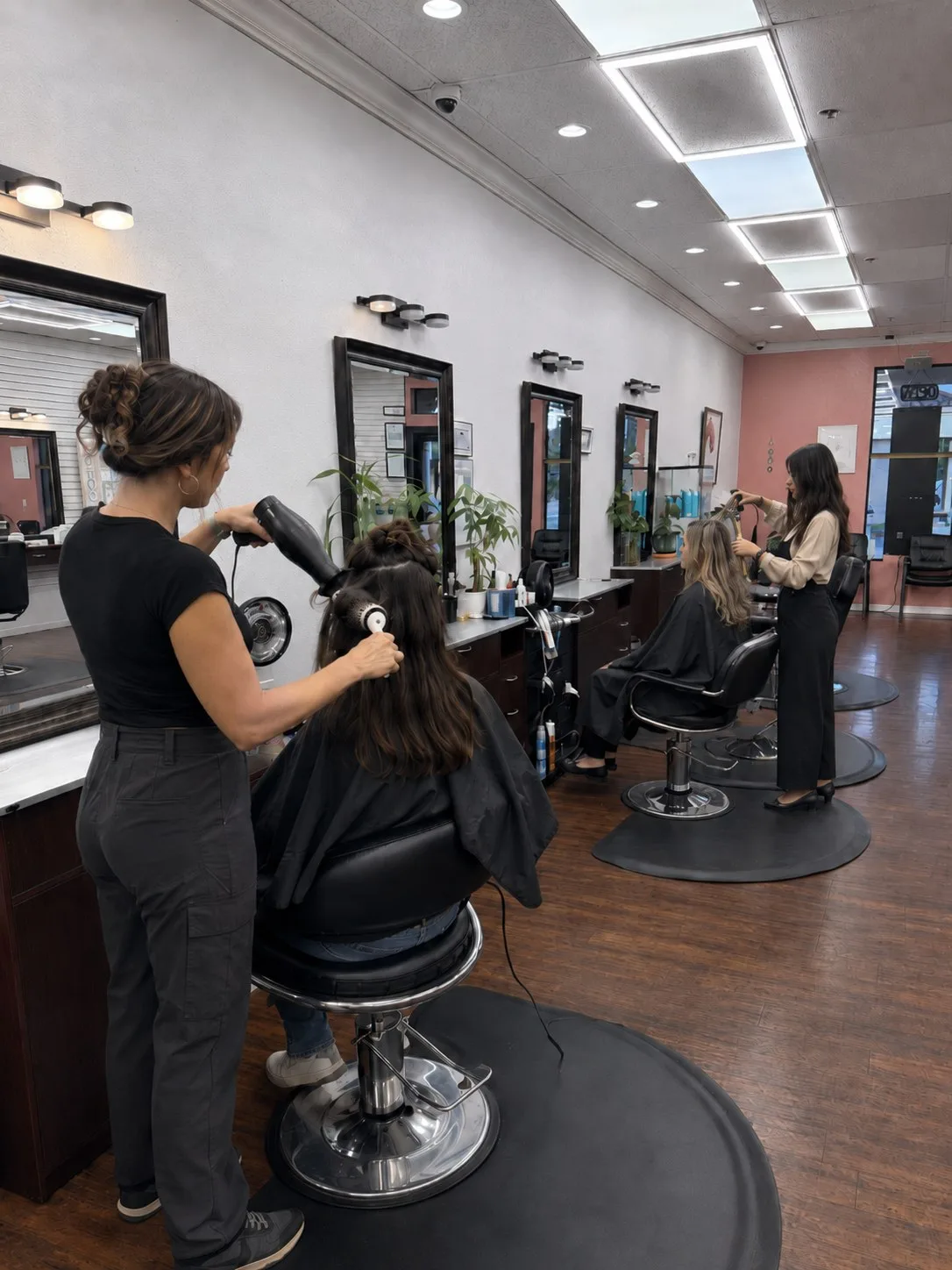 Stylist finishing a blowout at a PT Salon Pleasanton station