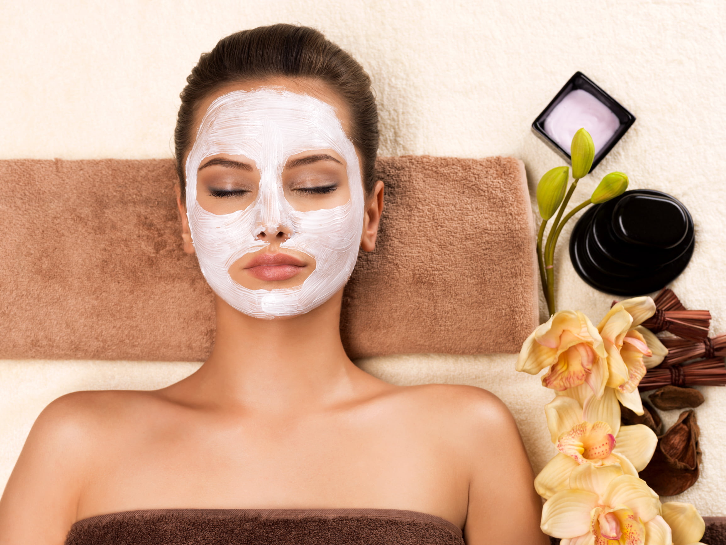 Young woman with mask on her face relaxing in PT Salon.